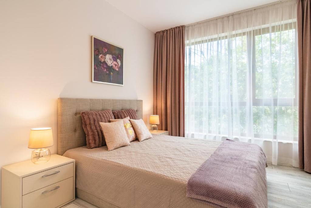 A bed or beds in a room at La Mer Residence