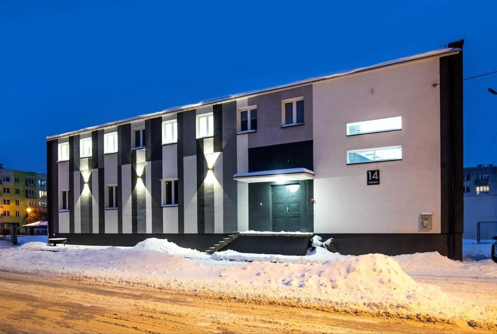 a building on a street in the snow at Marathon Noclegi in Skarżysko-Kamienna