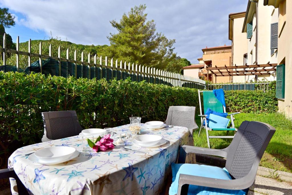 a table with a blue and white table cloth and chairs at Appartamento La Fenicia in Marciana Marina