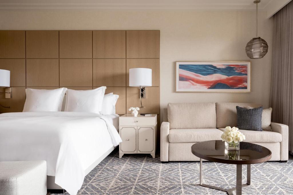 a hotel room with a bed and a couch at Four Seasons Resort Orlando at Walt Disney World Resort in Orlando