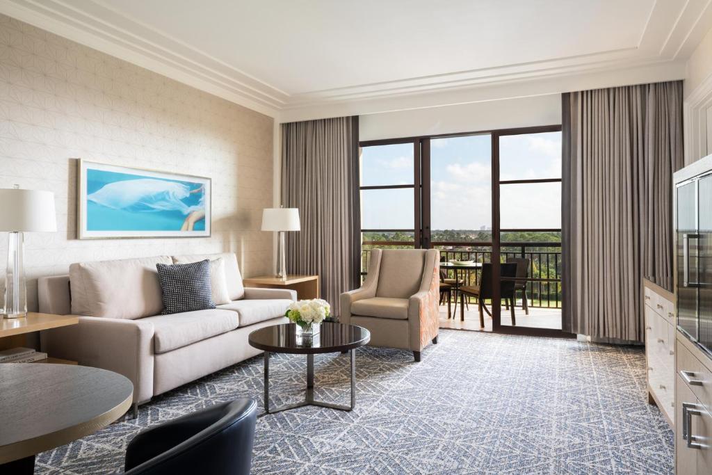 a living room with a couch and a table at Four Seasons Resort Orlando at Walt Disney World Resort in Orlando