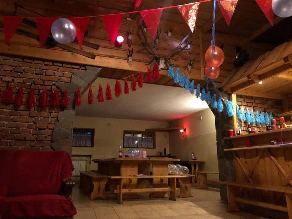 a living room with a table and a string of flags at Domek u Stocha in Poronin