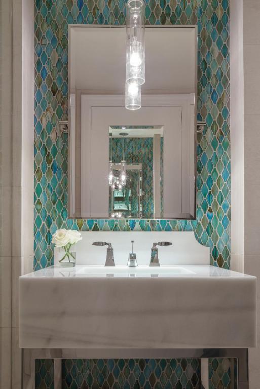 a bathroom with a white sink and a mirror at Four Seasons Resort Orlando at Walt Disney World Resort in Orlando