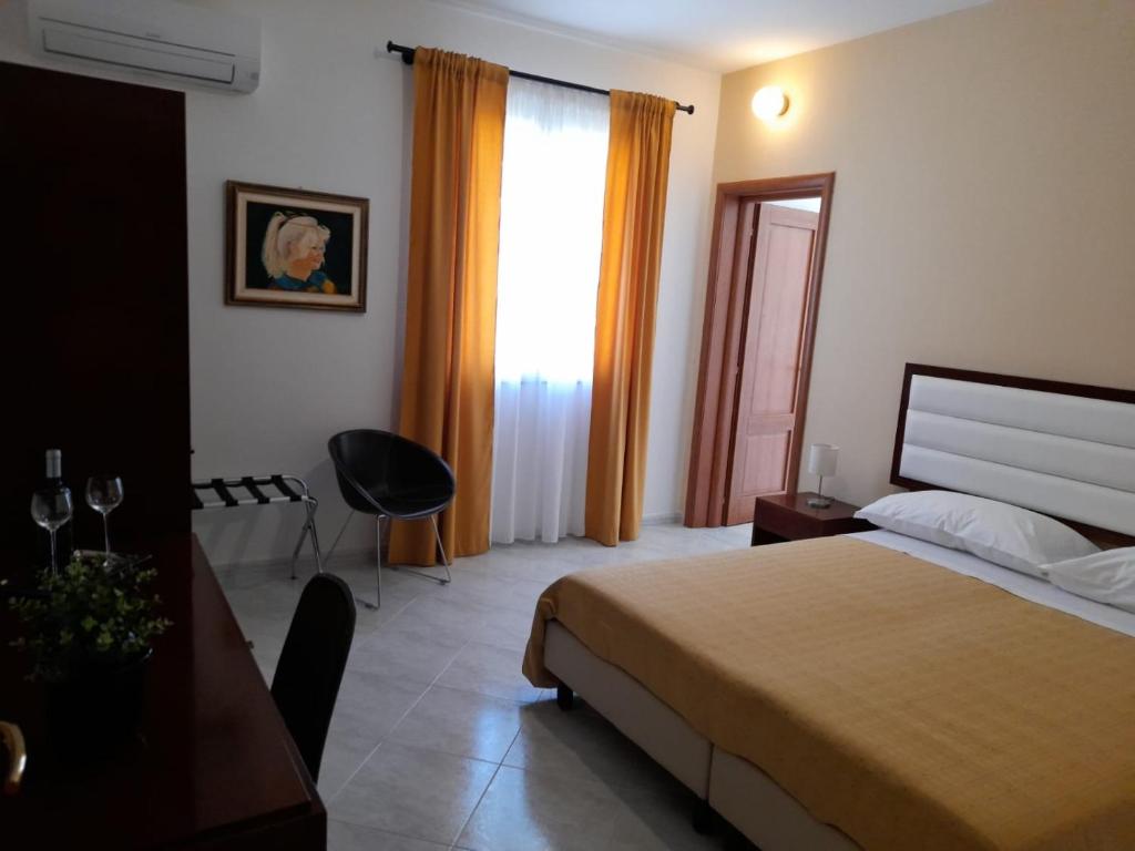 Posteľ alebo postele v izbe v ubytovaní Siracusa breakfast & rooms