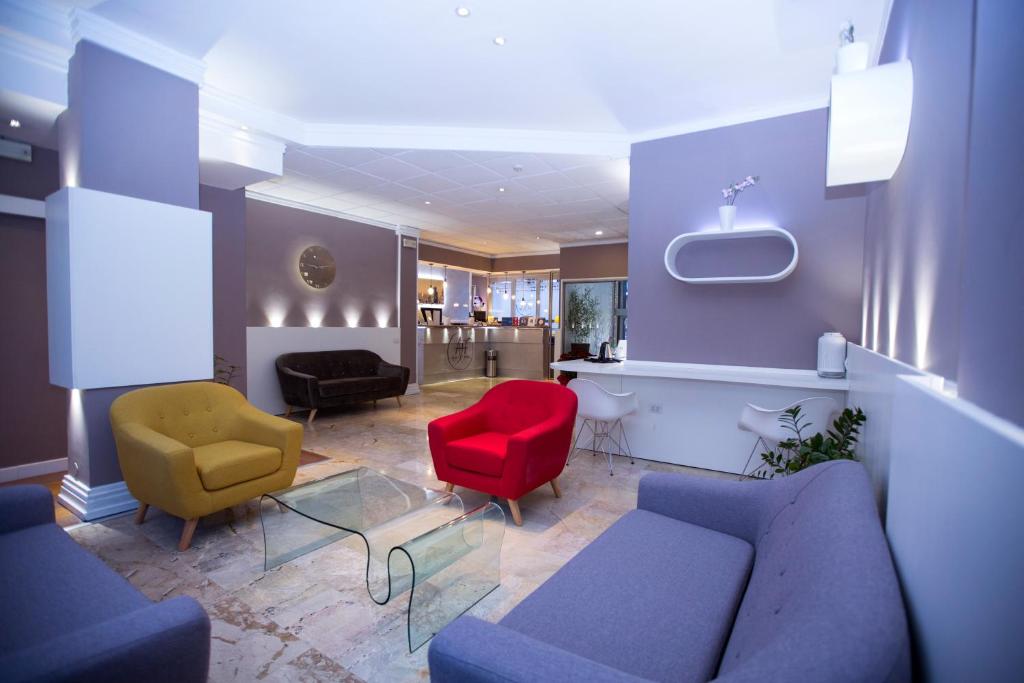 a living room with a couch and two chairs at Agape Hotel AA Hotels in Milan