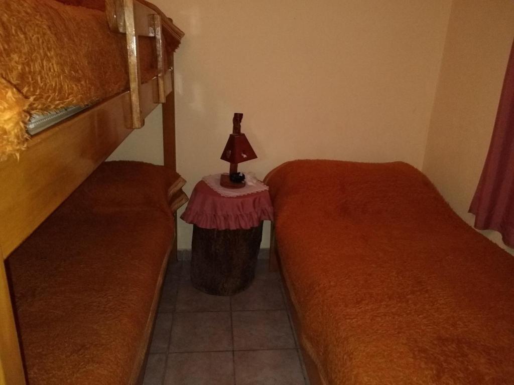 Postel nebo postele na pokoji v ubytování Cabañas Orión