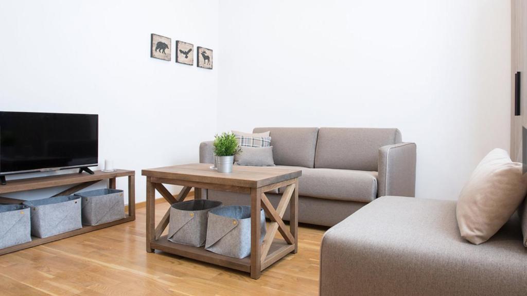 a living room with a couch and a table at Apartman Davidović in Brzeće