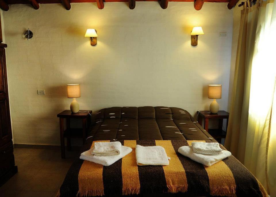 A bed or beds in a room at Cabanias El Aguaribay