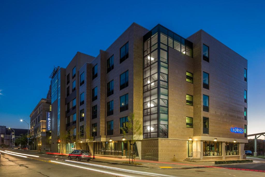 a building on a city street at night at Hotel Indigo Pittsburgh East Liberty by IHG in Pittsburgh