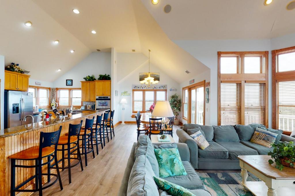 a living room with a couch and a bar at The Oaks #15-11 in Avon