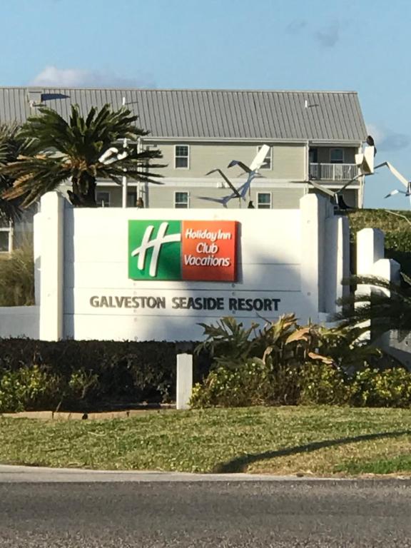 a building with a sign in front of a house at Holiday Inn Club Vacation Galveston Seaside Resort in Galveston