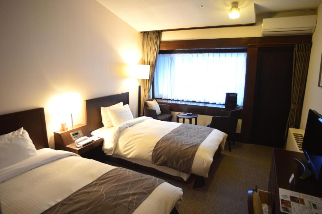 Postel nebo postele na pokoji v ubytování Yatsugatake Kogen Lodge