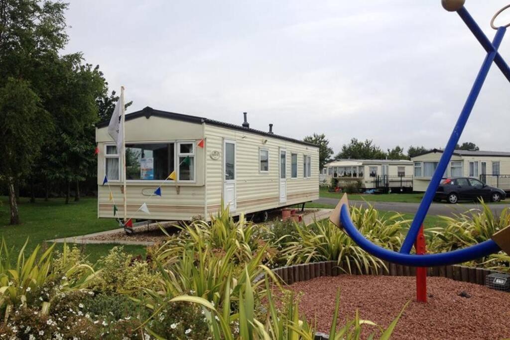 a small white caravan parked in a park at Great Deals at The Grange, Ingoldmells in Skegness