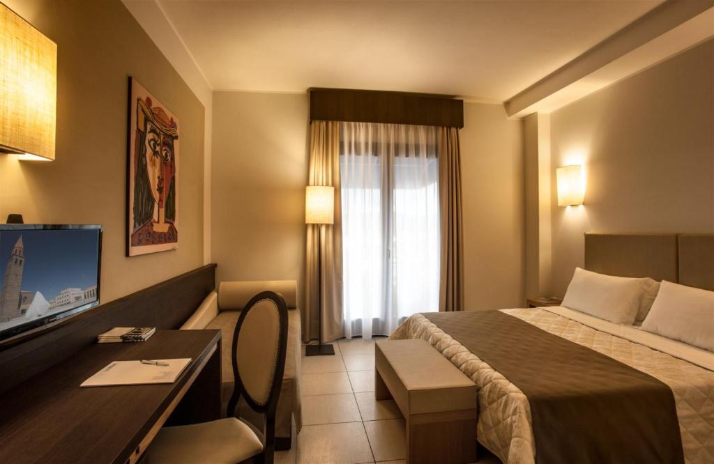 Postel nebo postele na pokoji v ubytování Lu' Hotel Carbonia