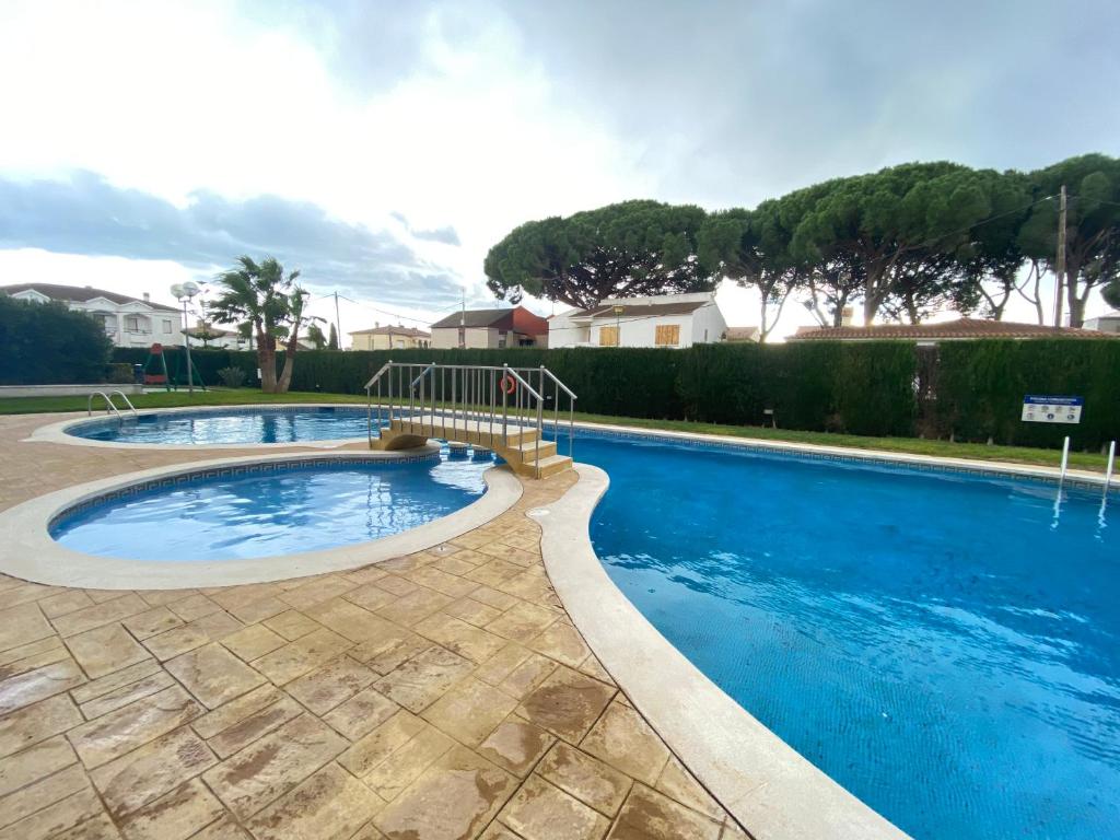 een groot zwembad met een glijbaan in een tuin bij RELAX i SOL in Cambrils