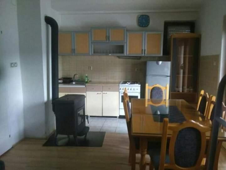 a kitchen with a table and a kitchen with a stove at Apartments Filemi in Ohrid