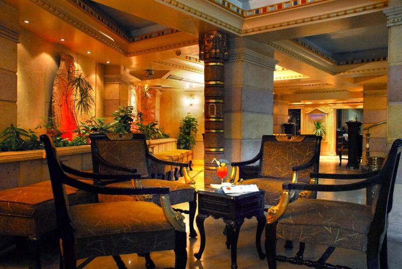 a lobby with chairs and a table in a building at Zayed Hotel in Cairo