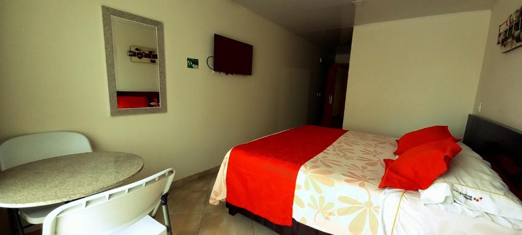 Postel nebo postele na pokoji v ubytování Hoteles Bogotá Inn Lago Chico Zona Rosa