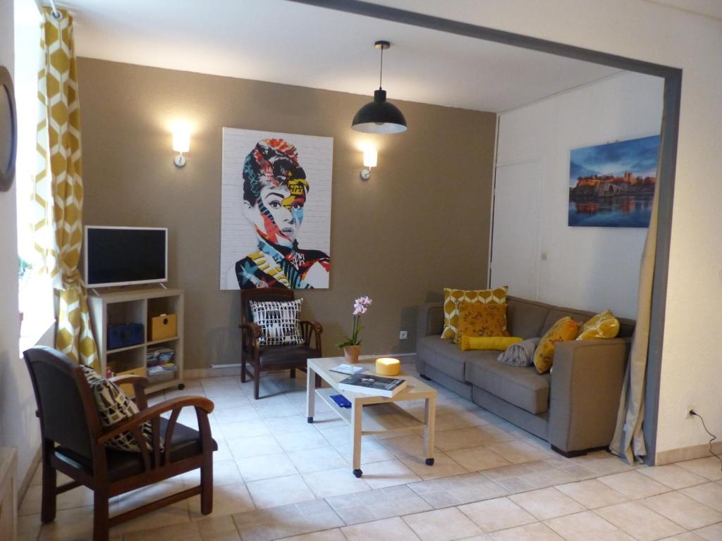 sala de estar con sofá y mesa en Chez Jean - Newly renovated air-conditioned flat at the foot of the ramparts, 4 people, en Carcassonne