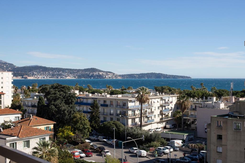 a view of a city with the ocean in the background at Studio with terrace and sea view, 10 min to the beach in Nice