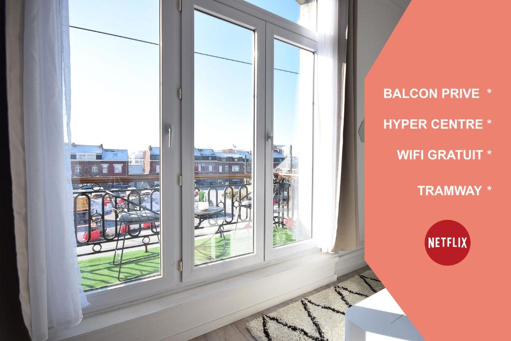 a room with a window with a view of a city at CHIC APPART DESIGN - HYPER CENTRE - TRAMWAY - FREE WIFI - leRelaisdOdile12 in Valenciennes