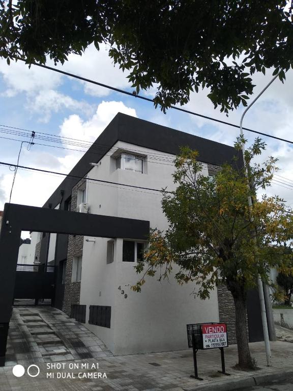 a white building with a sign in front of it at Vista Angular in Tandil