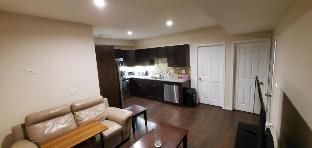 a living room with a couch and a kitchen at Parson Creek in Fort McMurray