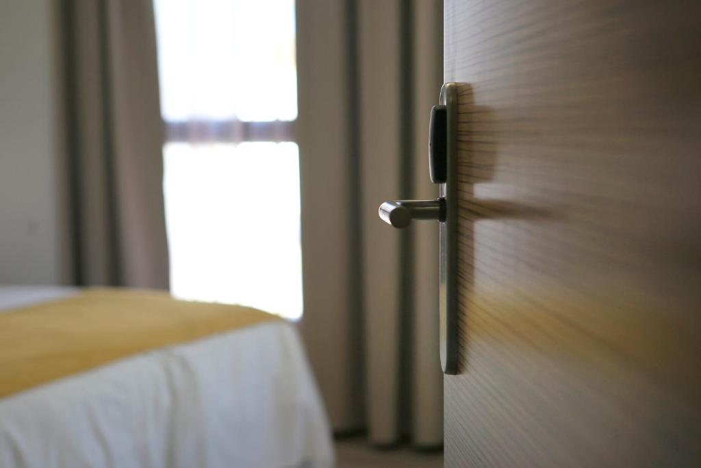 Postel nebo postele na pokoji v ubytování Hotel Leo