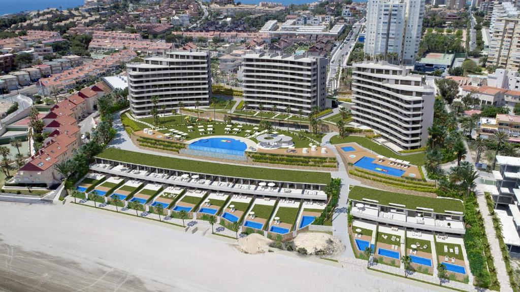 uma vista aérea de um edifício com um resort em 5* Apt, Best Location, Playa San Juan, heated pool em Alicante