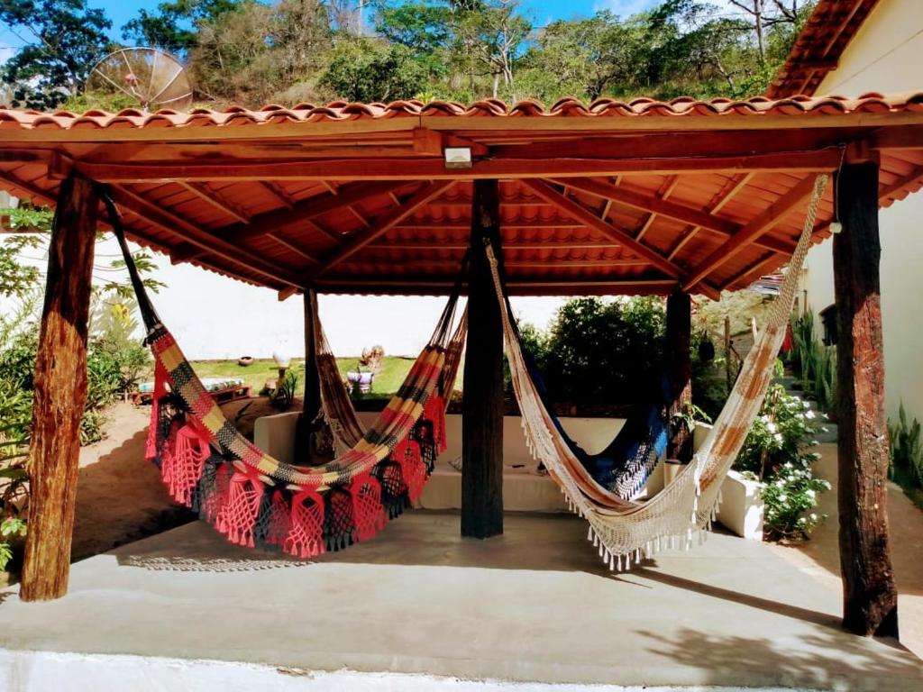 a couple of hammocks under a pergola at Pousada Vaca Brava in Areia