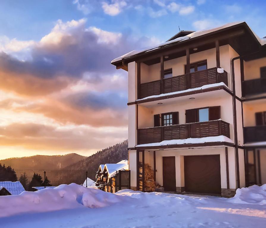 ein Gebäude mit Schnee davor in der Unterkunft Snowflake Chalet ,Donovaly in Donovaly