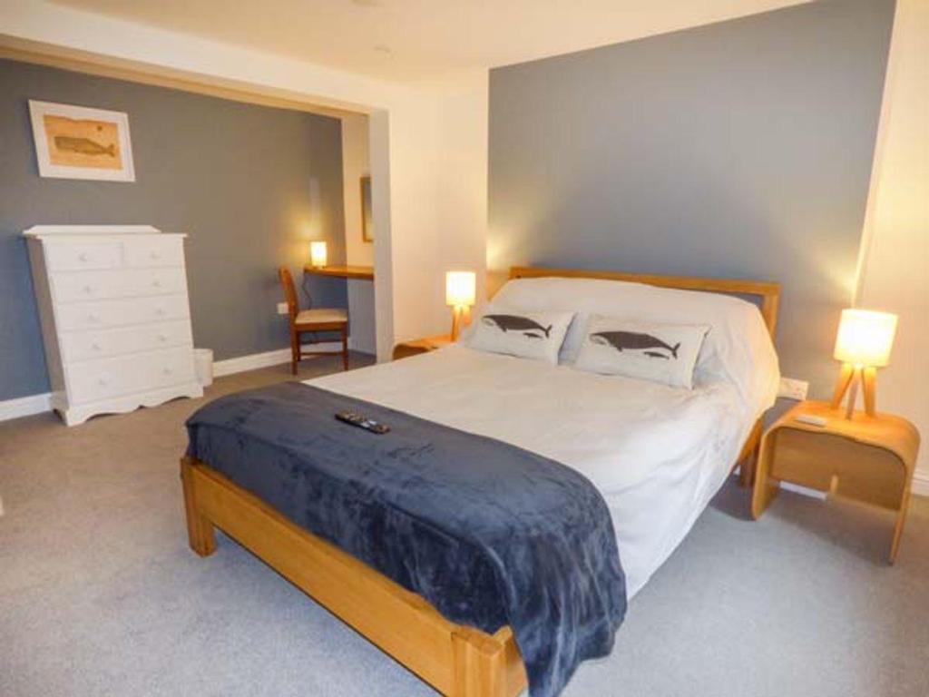 a bedroom with a large bed with two pillows at Low Tide in Whitby