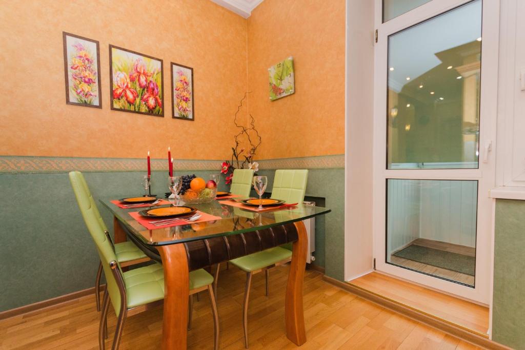 a dining room with a wooden table and chairs at Tverskaya 17 in Moscow