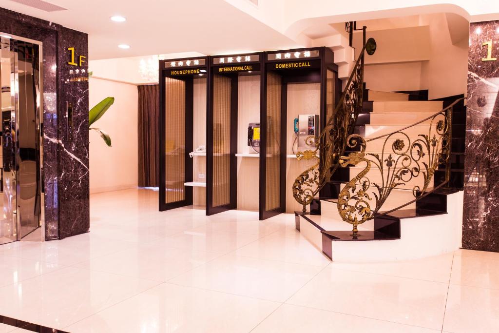 a store lobby with a row of doors and stairs at Harmonious Hotel in Kaohsiung
