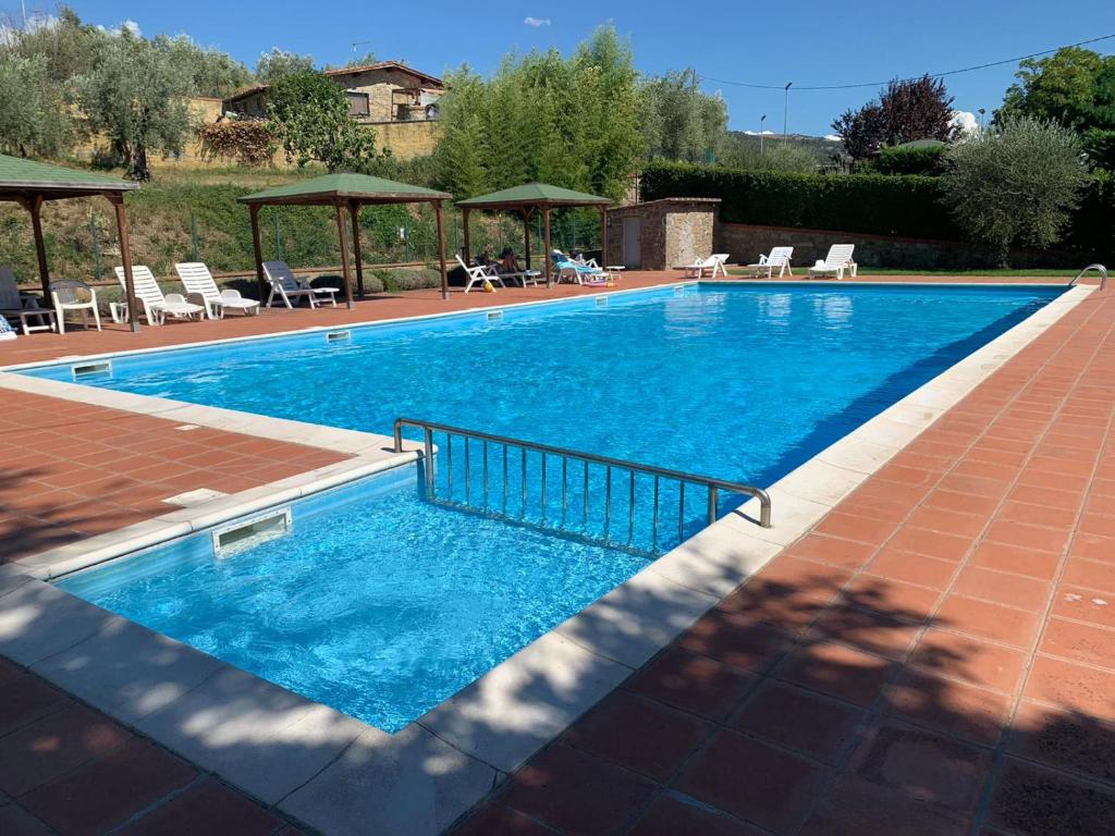 a large swimming pool with blue water at residence San miniato in Loro Ciuffenna