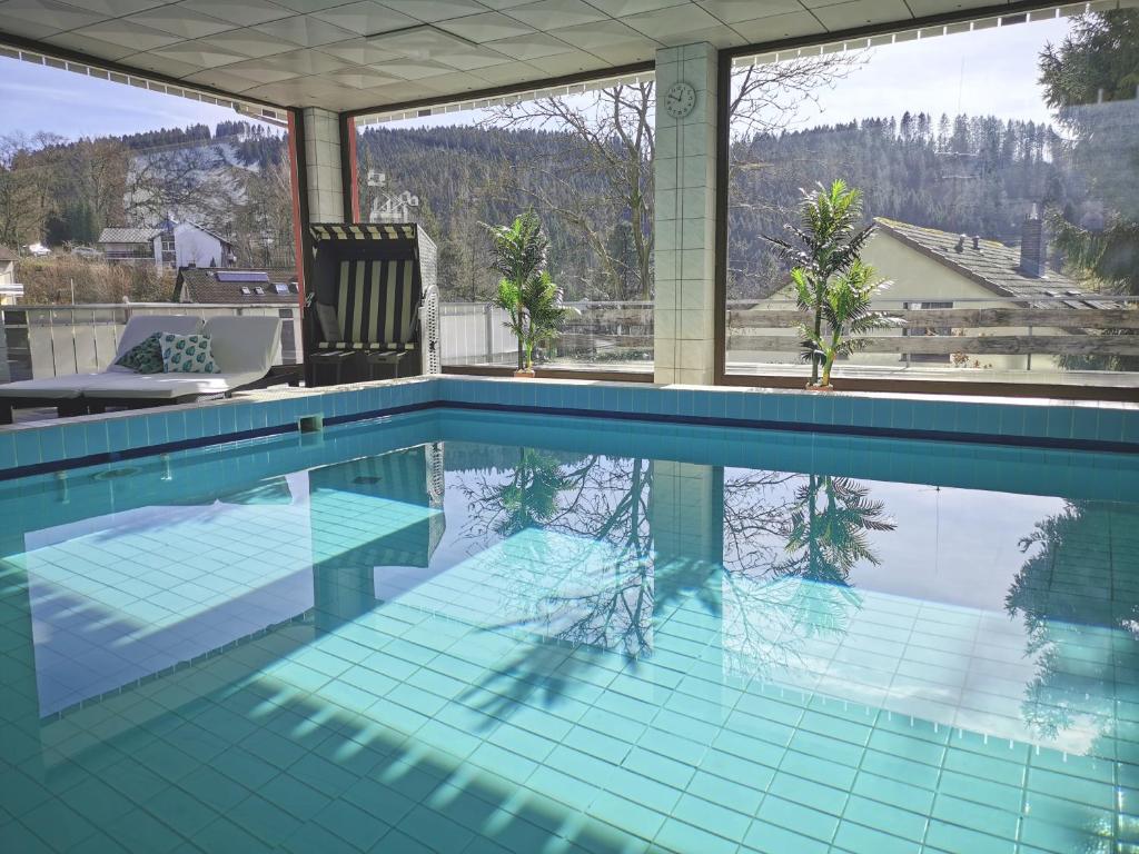 a swimming pool with a view of the mountains at Hotel Pension Jägerstieg in Bad Grund