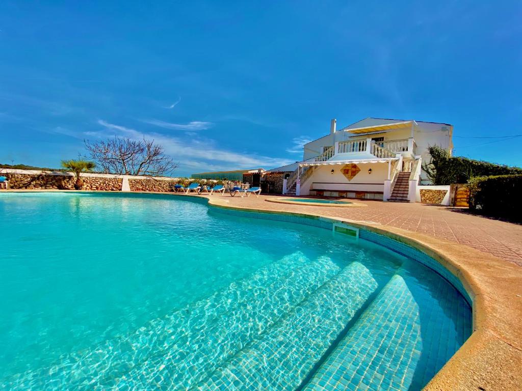 a swimming pool in front of a house at Agroestancia Lloc Nou en Ciutadella de Menorca in Ciutadella