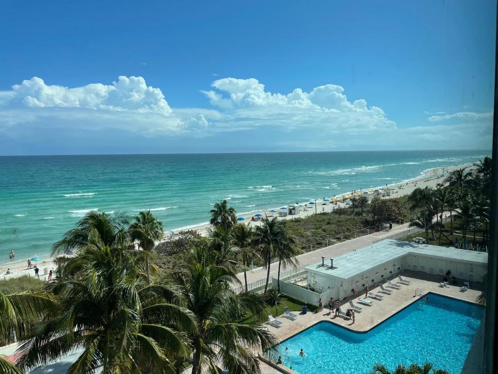 a view of the beach from the balcony of a resort at Beach Front Studio Miami Beach in Miami Beach