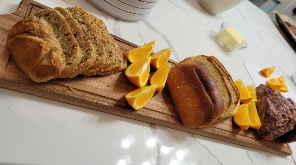 a cutting board with a loaf of bread and orange slices at La Maison de Sophie in Niagara-on-the-Lake