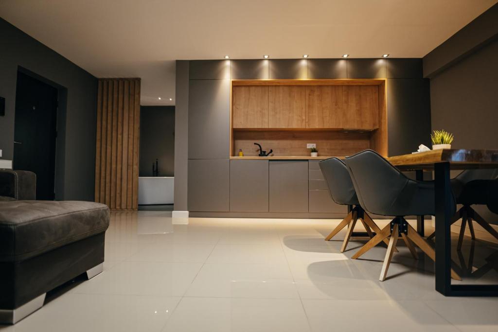 a kitchen with a table and chairs in a room at Thome Arena Residence in Cluj-Napoca