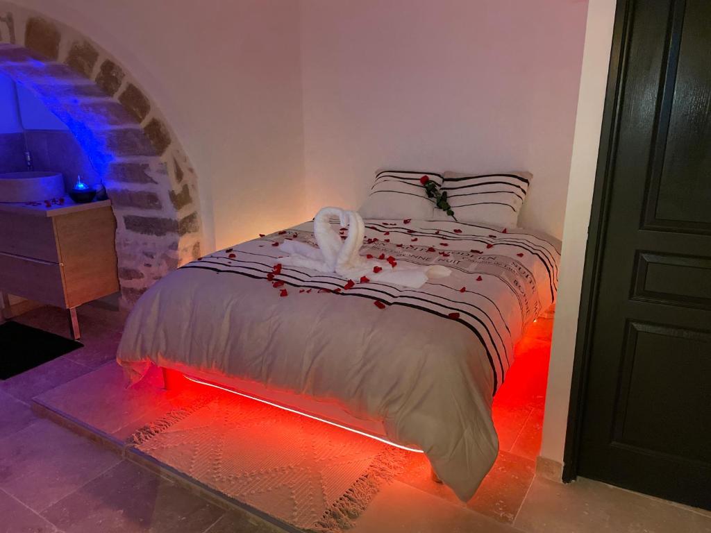 um quarto com uma cama com uma luz no chão em LE SPA INSOLITE DE MALAUCENE em Malaucène