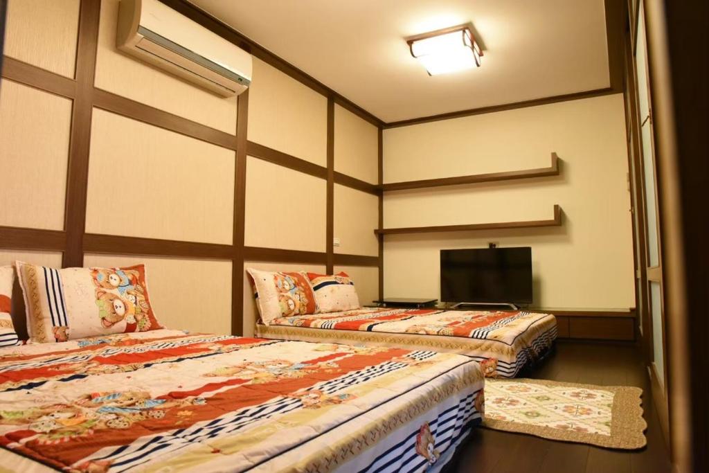 Postel nebo postele na pokoji v ubytování Lvyou B&B