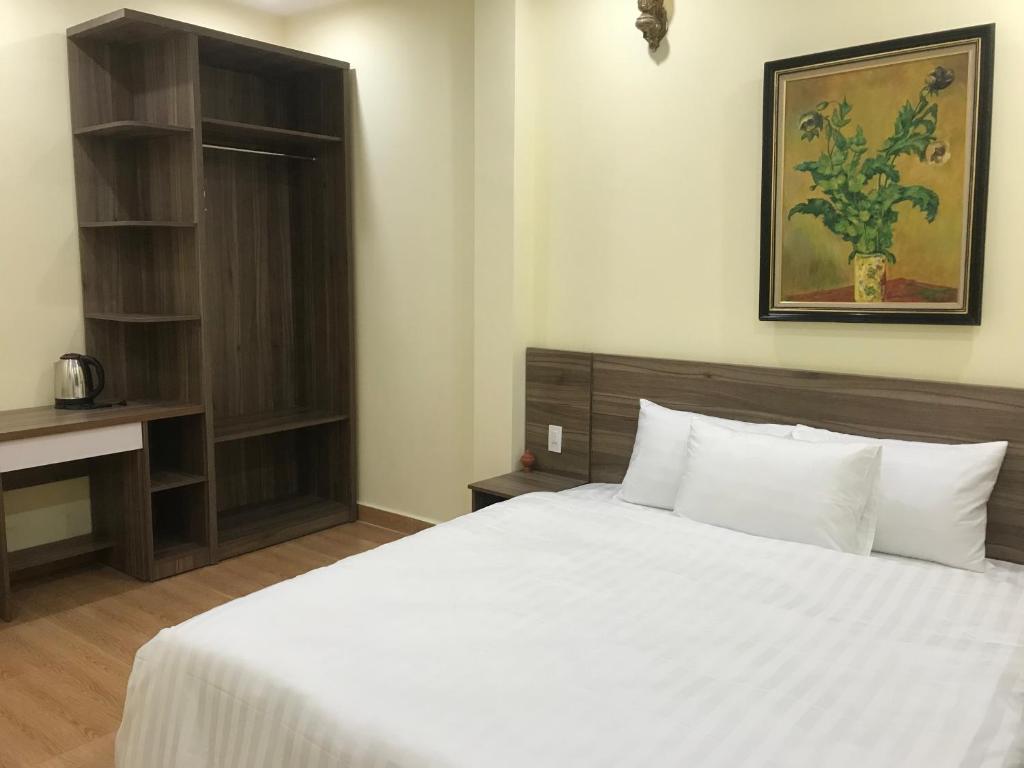 Postel nebo postele na pokoji v ubytování Ngoc Tran Hotel