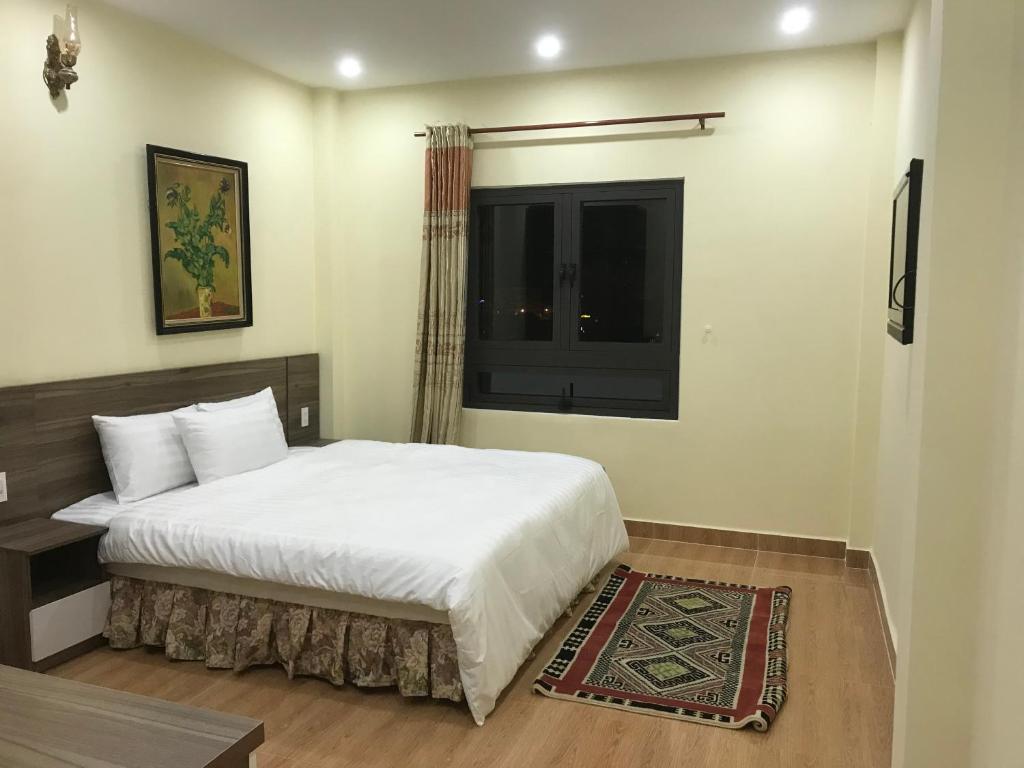 Postel nebo postele na pokoji v ubytování Ngoc Tran Hotel