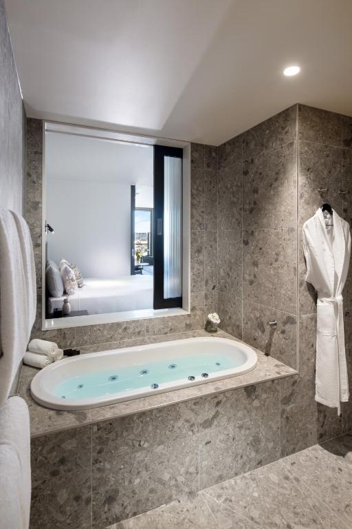 e bagno con finestra e vasca. di Majestic M Suites a Adelaide