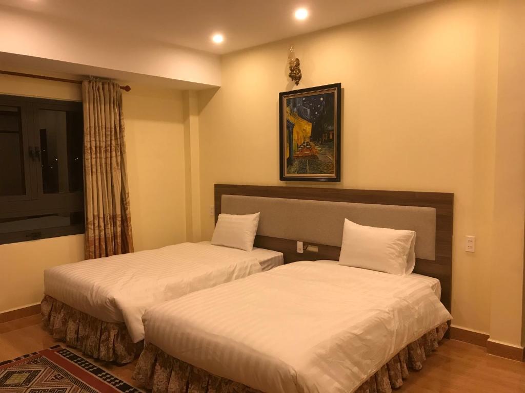 Postel nebo postele na pokoji v ubytování Ngoc Tran Hotel