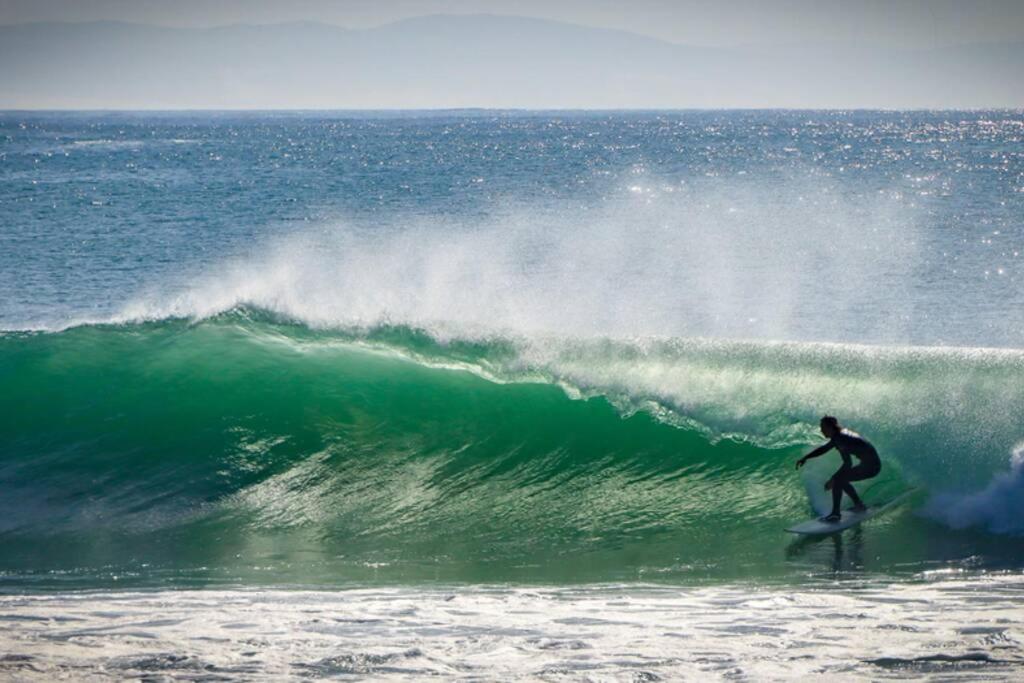 a man riding a wave on a surfboard in the ocean at 16 Flame@ Supertubes, Luxury room, Jeffreys Bay in Jeffreys Bay
