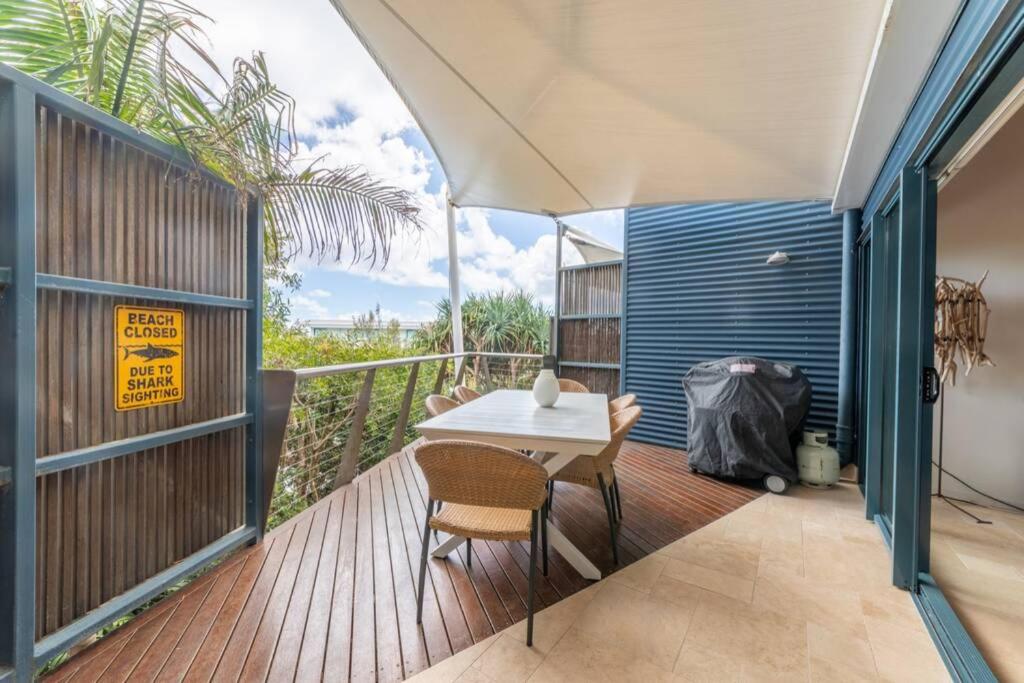 a patio with a table and chairs on a deck at Saltwater 5 - sleeps 8 - close to Main Beach in Point Lookout