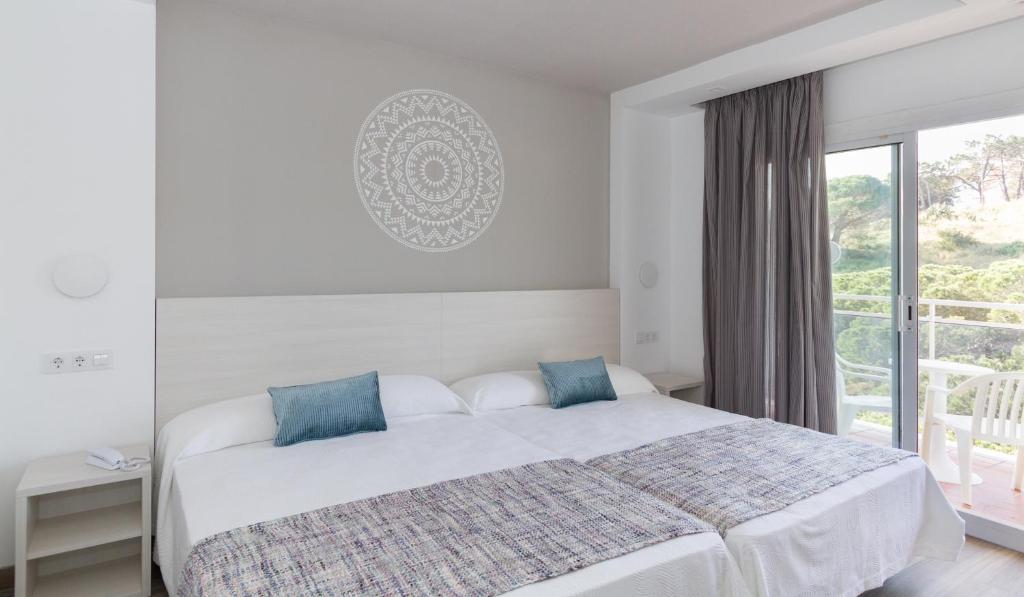 Postel nebo postele na pokoji v ubytování Hotel Oasis Park Splash