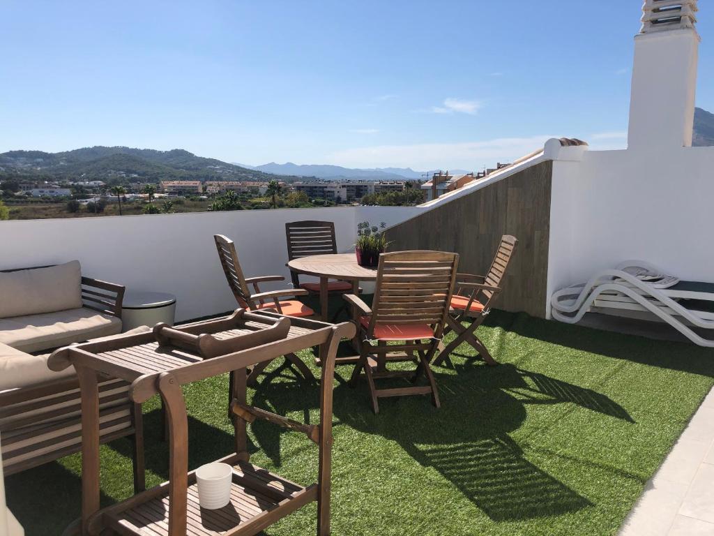 a patio with chairs and a table on a balcony at Ático a 200m del mar. in Jávea